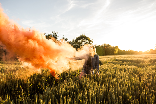 A smoke bomb photograph captured in a field in Denmark